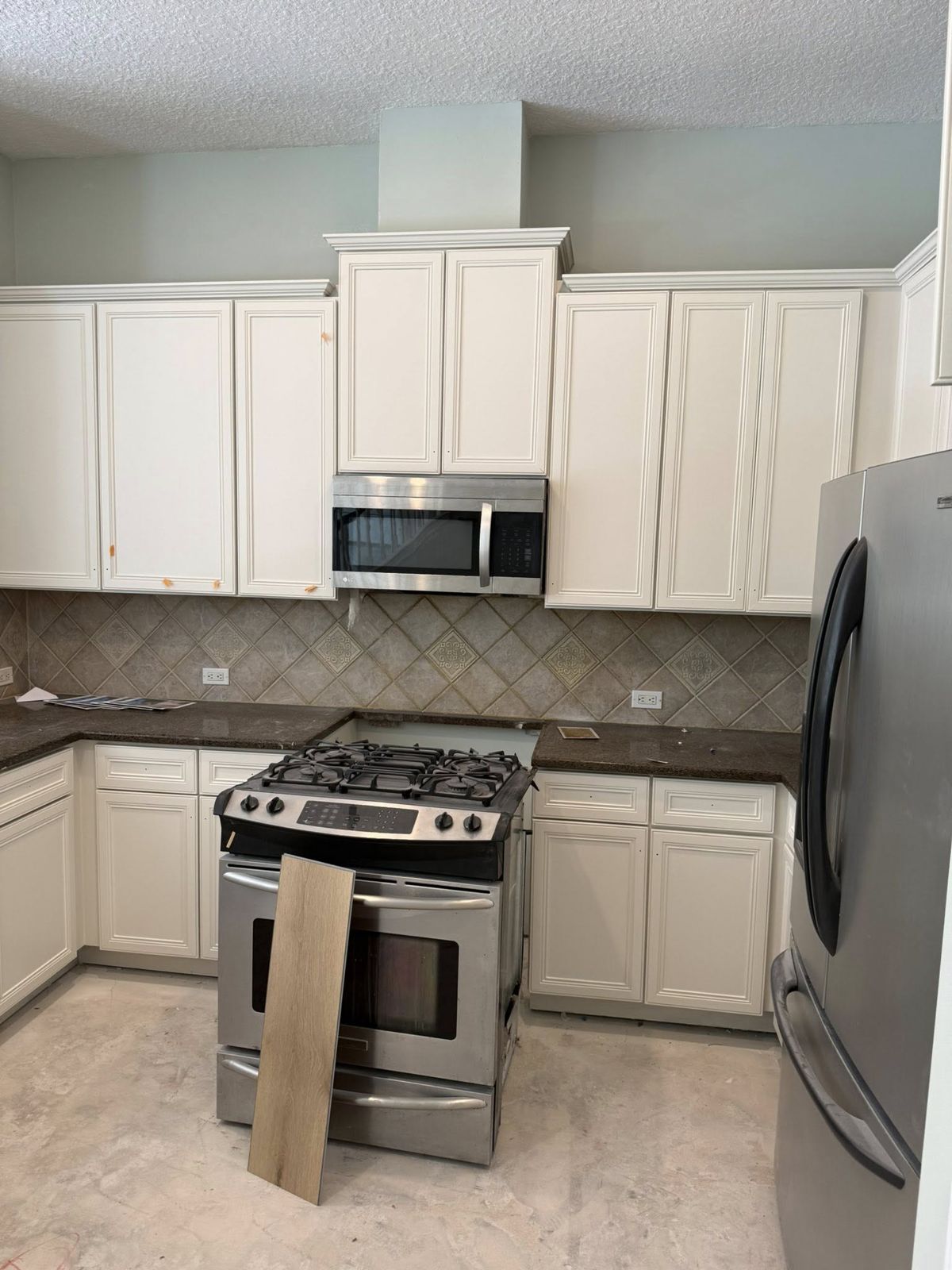 The same kitchen with cabinets painted bright white by Strait Edge Painting in Jacksonville