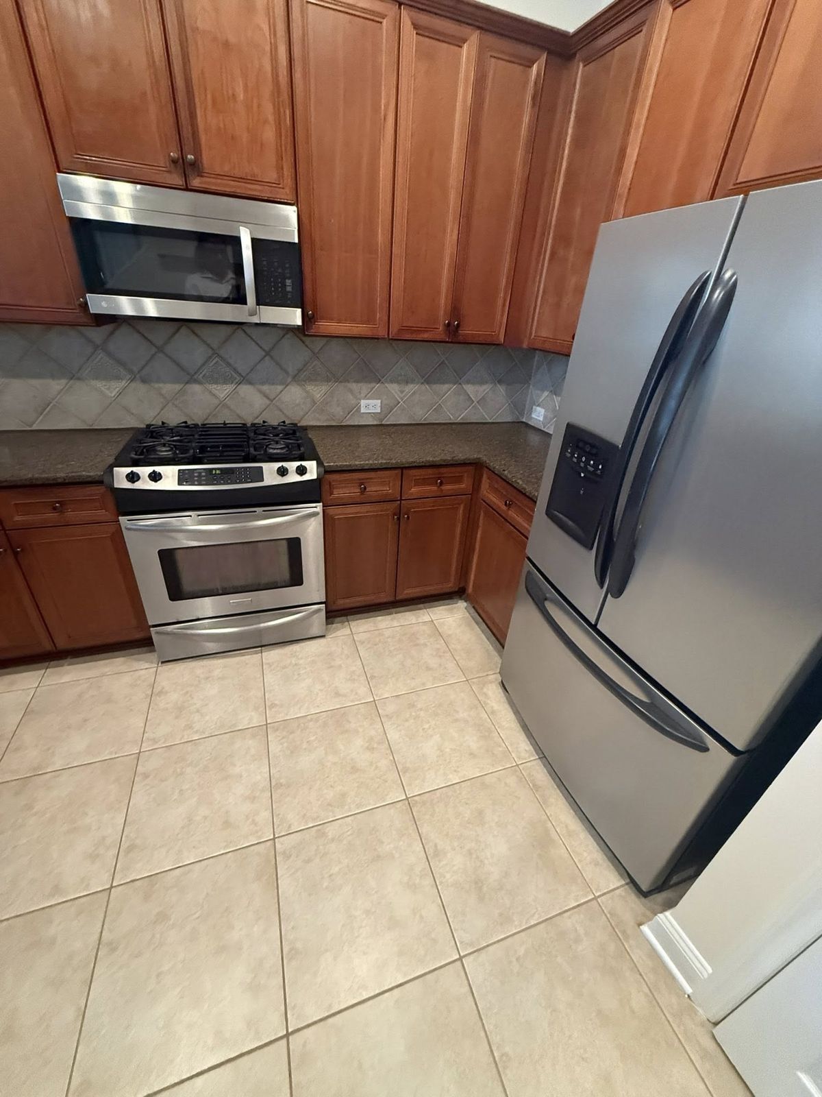 Wood-toned kitchen cabinets in Jacksonville before painting