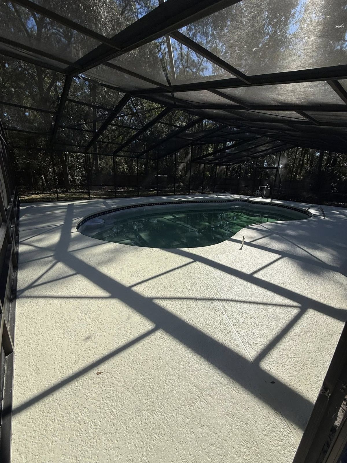 The same Jacksonville pool deck after a fresh decorative coating by Strait Edge Painting