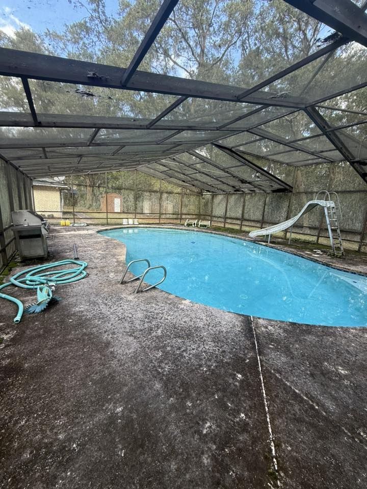 Weathered, stained pool deck in Jacksonville, FL before resurfacing